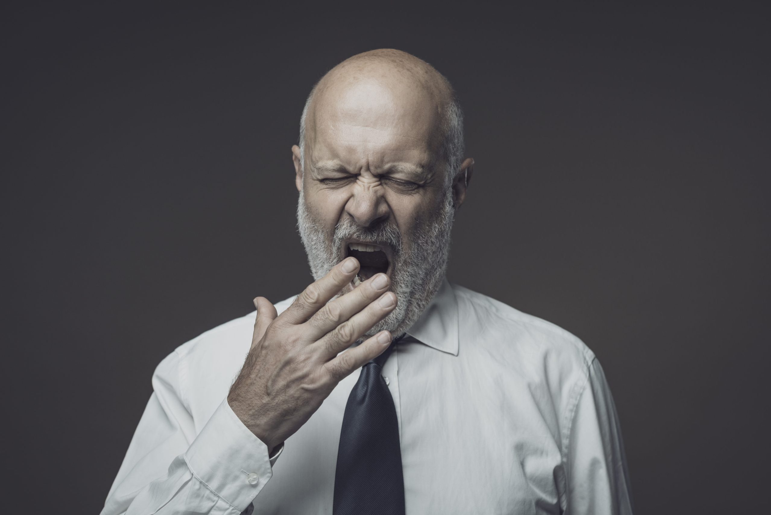 Lazy tired businessman yawning