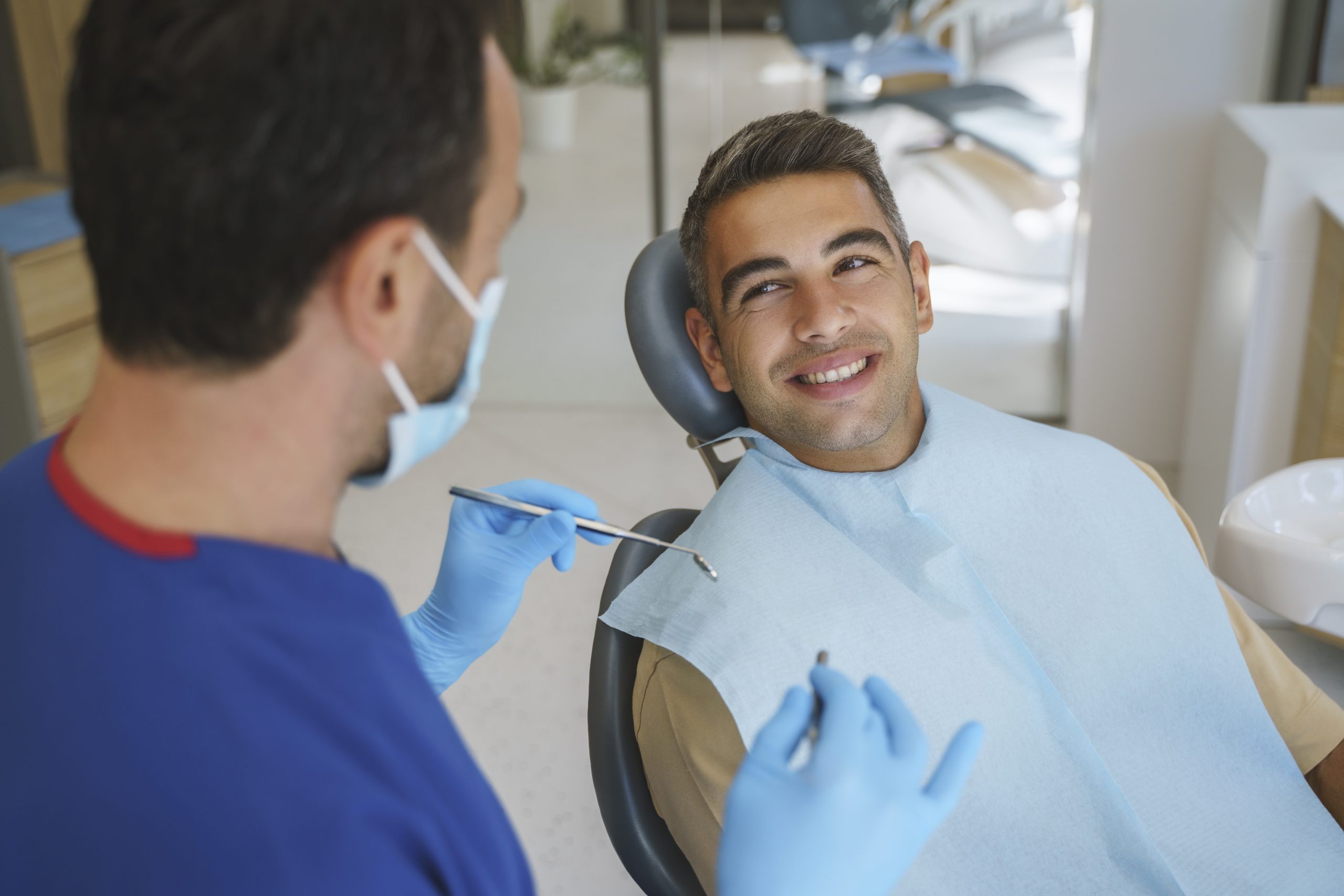 Young man patient having dental treatment at dentist's office